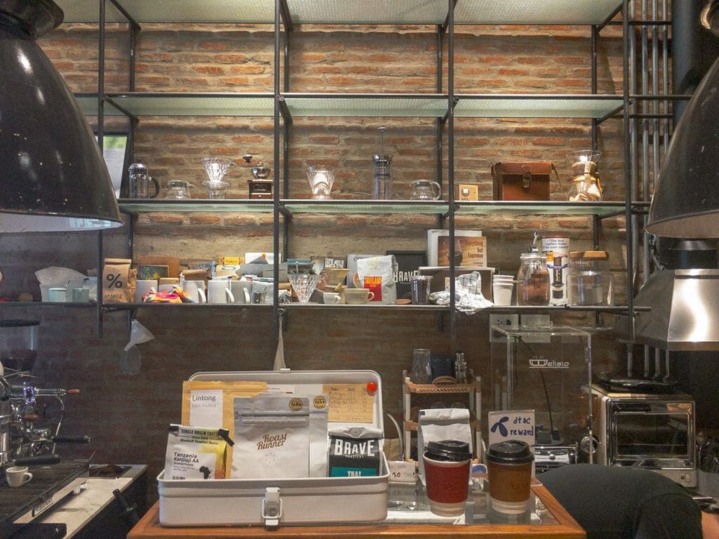 Wall of coffee gear and beans inside At.is coffee in Bangkok.