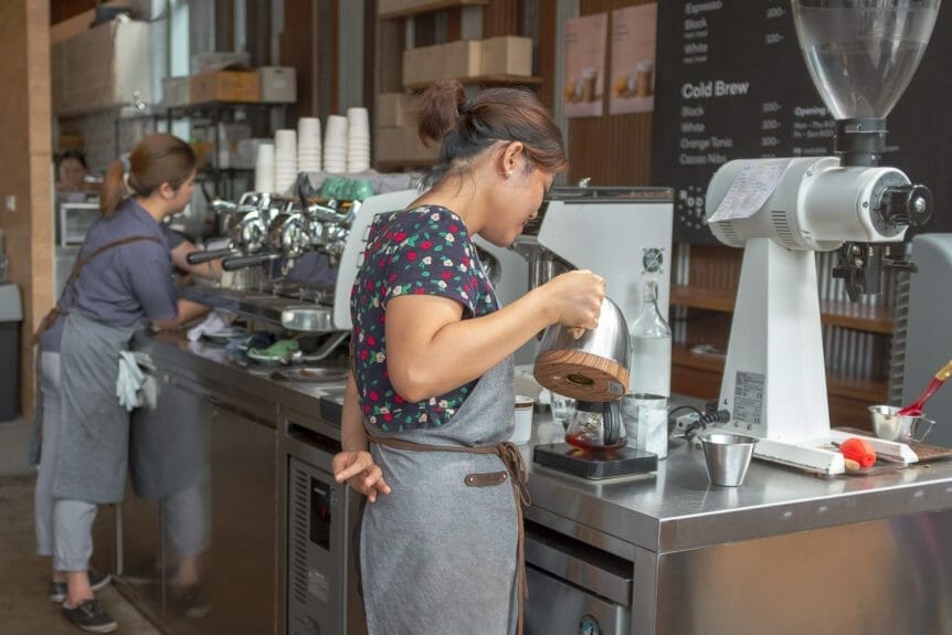 Barista preparing coffee at Roots in Bangkok.