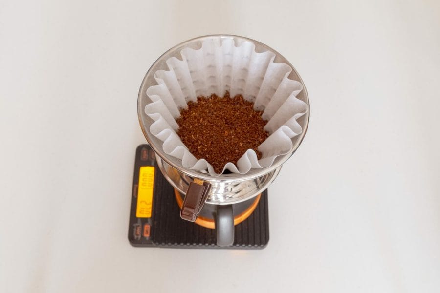 Kalita Wave filled with coffee on top of a mug and scale