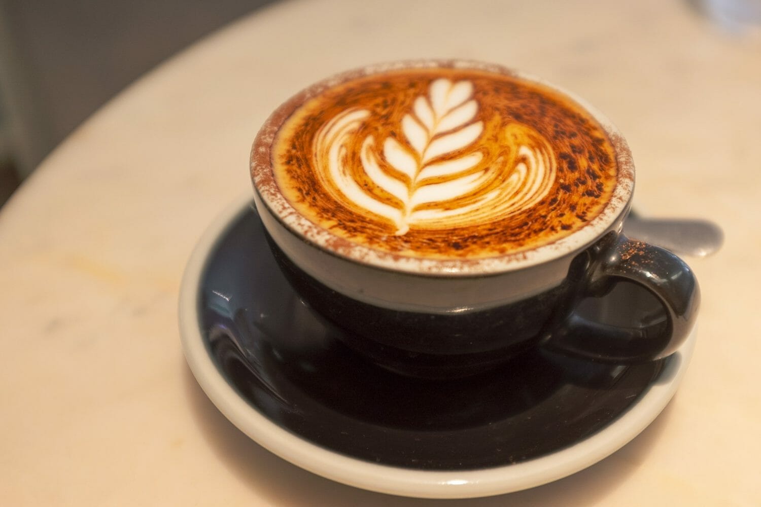 Cappuccino close-up with dusting of cocoa.