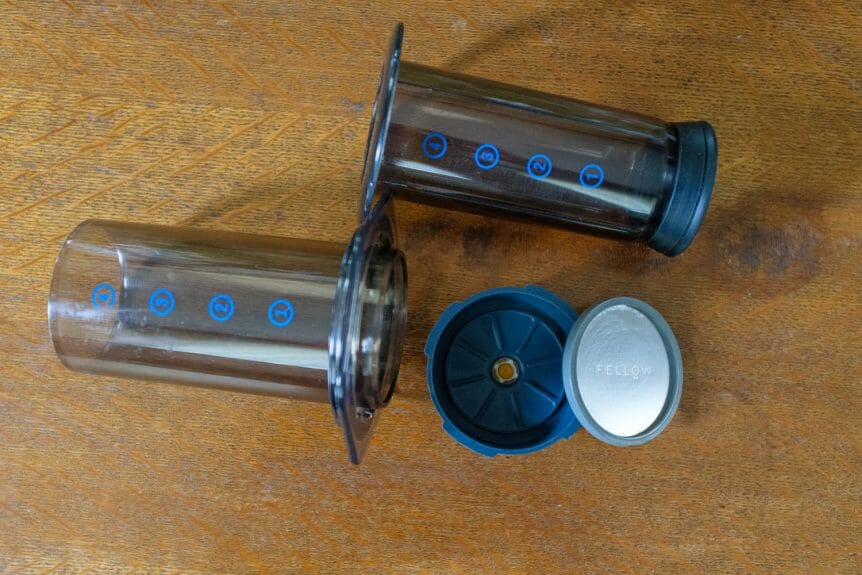 Aeropress and Fellow Prismo taken apart. View from above with Aeropress numbers showing and Prismo filter resting on the outer attachment