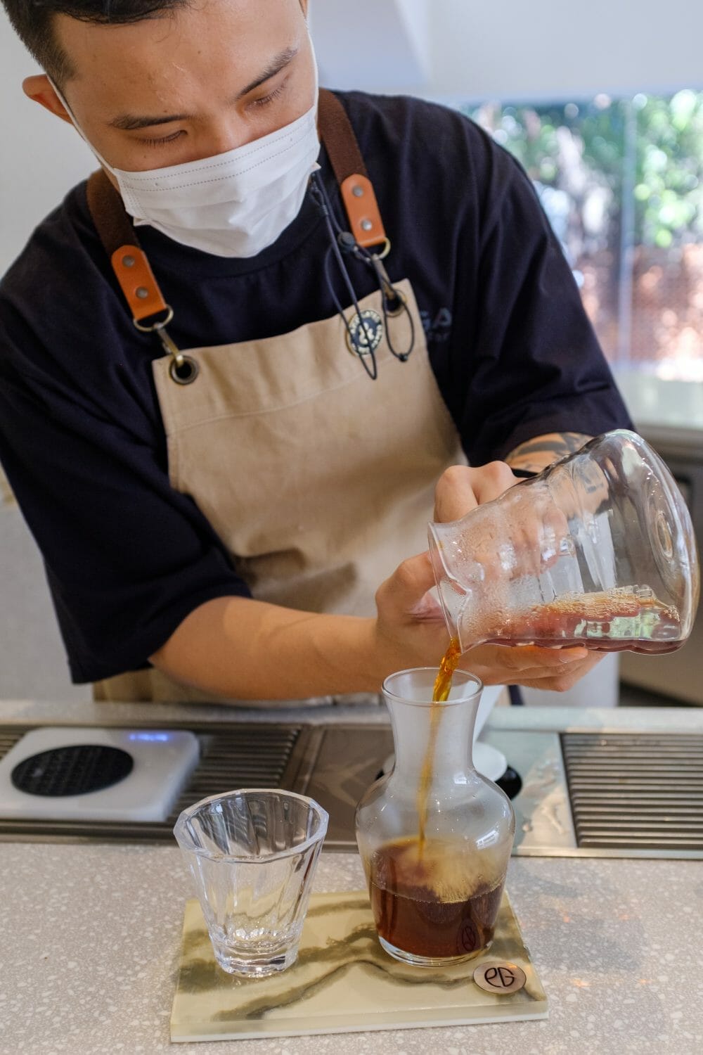 Barista pouring coffee